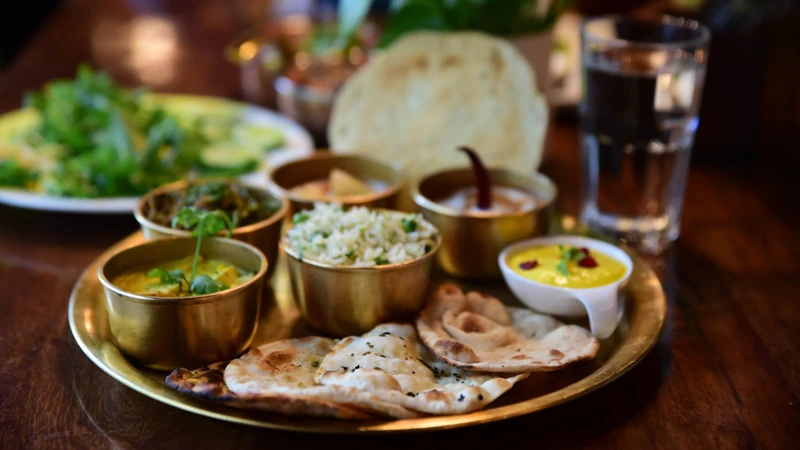 Gourmet Indian set meal with homemade curries and fresh ingredients.